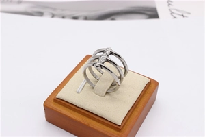 Detailed view of silver triple-layered stainless steel ring on a jewelry display