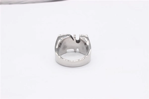 Detailed top view of vintage silver steel ring with CD cutout design on white surface