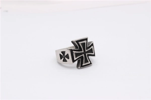 Detail of vintage biker ring showing the embossed iron cross symbol with a black finish