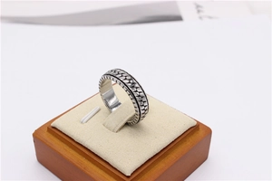 Macro shot of retro silver titanium steel ring with intricate scale texture on display
