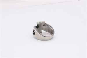 Detail of vintage silver titanium steel ring featuring a black maltese cross engraving
