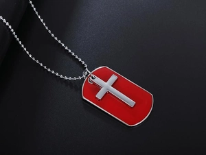 Detail of red enamel dog tag pendant with silver cross and bead chain for men