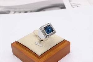 Macro view of signet ring with blue gemstone and Greek Key pattern on stainless steel