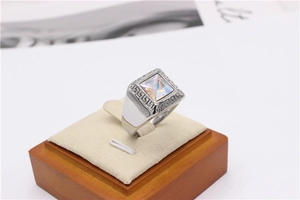 Detailed view of silver titanium steel ring with square colorful stone and fret pattern
