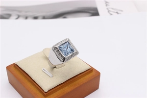 Macro detail of men's titanium ring with square blue gemstone and Greek meander patterns