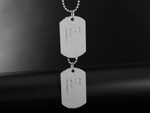 Macro shot of double stainless steel military dog tags with custom info engraving