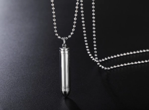 Detailed close-up of polished bullet pendant necklace with a sleek bead chain in silver