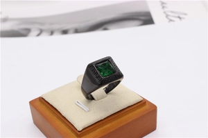 Detail of square emerald gemstone ring with Greek fret pattern in black titanium steel