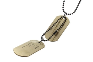 Detailed macro view of bronze dog tag necklaces with NAME, TEL, BIRTH and BLOODTYPE engraving