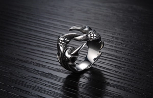 Gros plan d'une bague griffe de dragon rétro montrant la texture des écailles et les détails