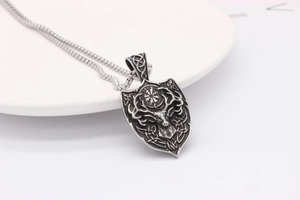 Detailed macro view of vintage elk shield pendant with Viking compass engraving