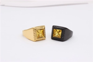 Detail of square yellow gemstone rings with Greek meander patterns in gold and black