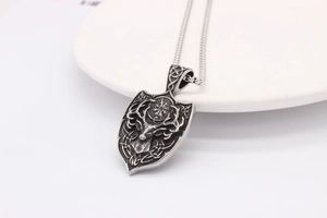 Detail view of retro silver viking deer head pendant with celtic knot patterns