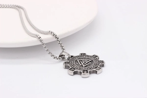Macro detail of silver Valknut pendant with Rune engraving and sturdy steel box chain