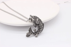 Detailed macro view of vintage koi fish pendant with intricate scales and S. Steel mark