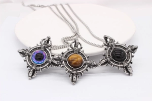 Detailed view of punk cross pendants with tiger eye and purple resin beads on steel chains