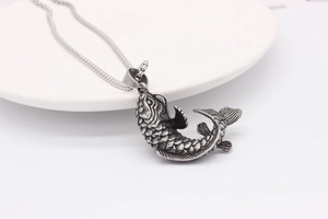 Macro detail of retro koi fish pendant showing intricate scales and oxidized silver finish
