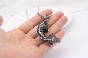 Macro detail of retro koi fish pendant in vintage silver steel with intricate scales