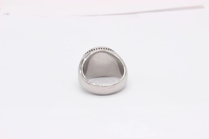 Detailed top view of a wide silver stainless steel signet ring with beaded edge detail
