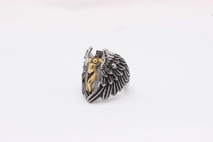 Macro shot of retro angel wing ring with golden female figure and feather textures