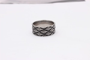 Macro shot of retro dragon scale texture and black antique finish on men steel ring