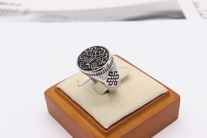 Macro detail of retro steel signet ring with Tree of Life and Celtic knot motifs