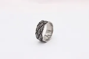 Close-up of vintage dragon scale textured steel ring with oxidized silver finish