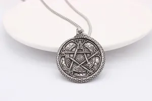 Macro detail of silver vintage Viking pentagram pendant with Celtic knotwork design