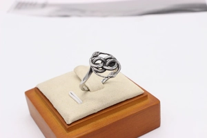 Macro detail of retro double snake ring with intricate scale textures on a display stand