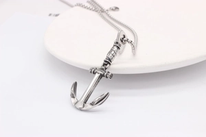 Detail shot of vintage stainless steel anchor pendant with rustic oxidised finish