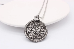 Detailed close-up of retro silver Viking Tree of Life pendant with scaly texture
