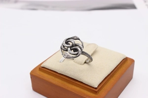 Detailed view of silver double snake ring with vintage textured scales and infinity design