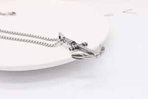Close-up of vintage anchor pendant in oxidized stainless steel with ball chain