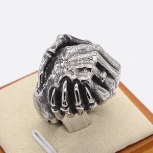 Gothic punk style handshake skull ring in vintage silver finish on a jewelry display