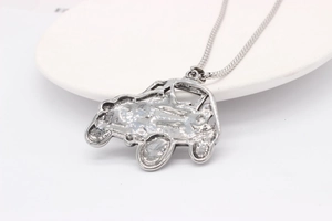 Macro detail of retro silver off-road car pendant with forged texture on steel chain
