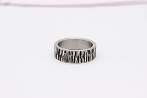 Macro detail of industrial steel ring with vintage bark texture and silver-black finish