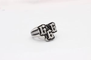 Macro shot of retro 666 stainless steel ring with gothic embossing and black oxidation
