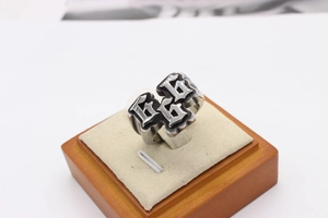 Macro shot of retro gothic steel ring with 666 relief detail on beige jewelry stand