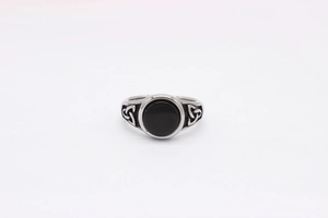 Detailed view of Viking steel ring featuring a black stone and Celtic knot engravings