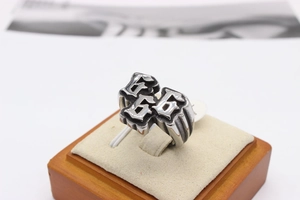 Detailed view of punk rock stainless steel ring featuring engraved 666 digits on velvet stand