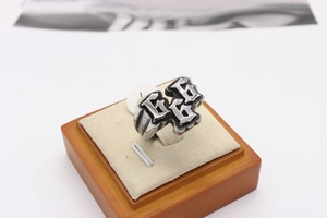 Macro shot of retro stainless steel ring with Gothic style 666 engraved pattern