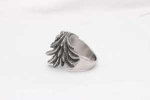 Macro shot of retro stainless steel ring featuring detailed layered wing textures