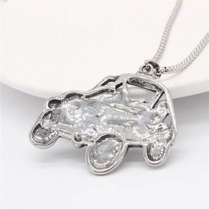 Retro off-road vehicle pendant necklace in silver stainless steel on white ceramic plate