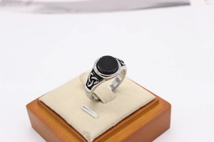 Macro detail of vintage Viking steel ring with black stone and Celtic knot carvings