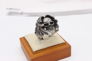 Detailed close-up of a retro gothic skull ring with wing textures on a jewelry stand