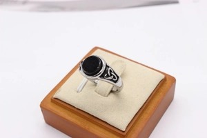 Macro detail of vintage Viking ring with black stone and Celtic knot engraving
