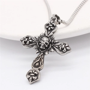 Vintage silver skull cross pendant necklace with gothic lily patterns on white background