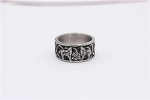 Macro detail of men's Viking wolf head engraving and Celtic knot textures on a steel ring