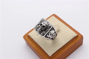 Macro detail of retro skull ring with rose floral relief and gothic vintage finish
