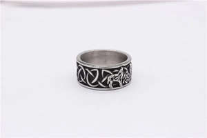 Close-up of vintage Viking wolf head and Celtic knot embossing on steel ring